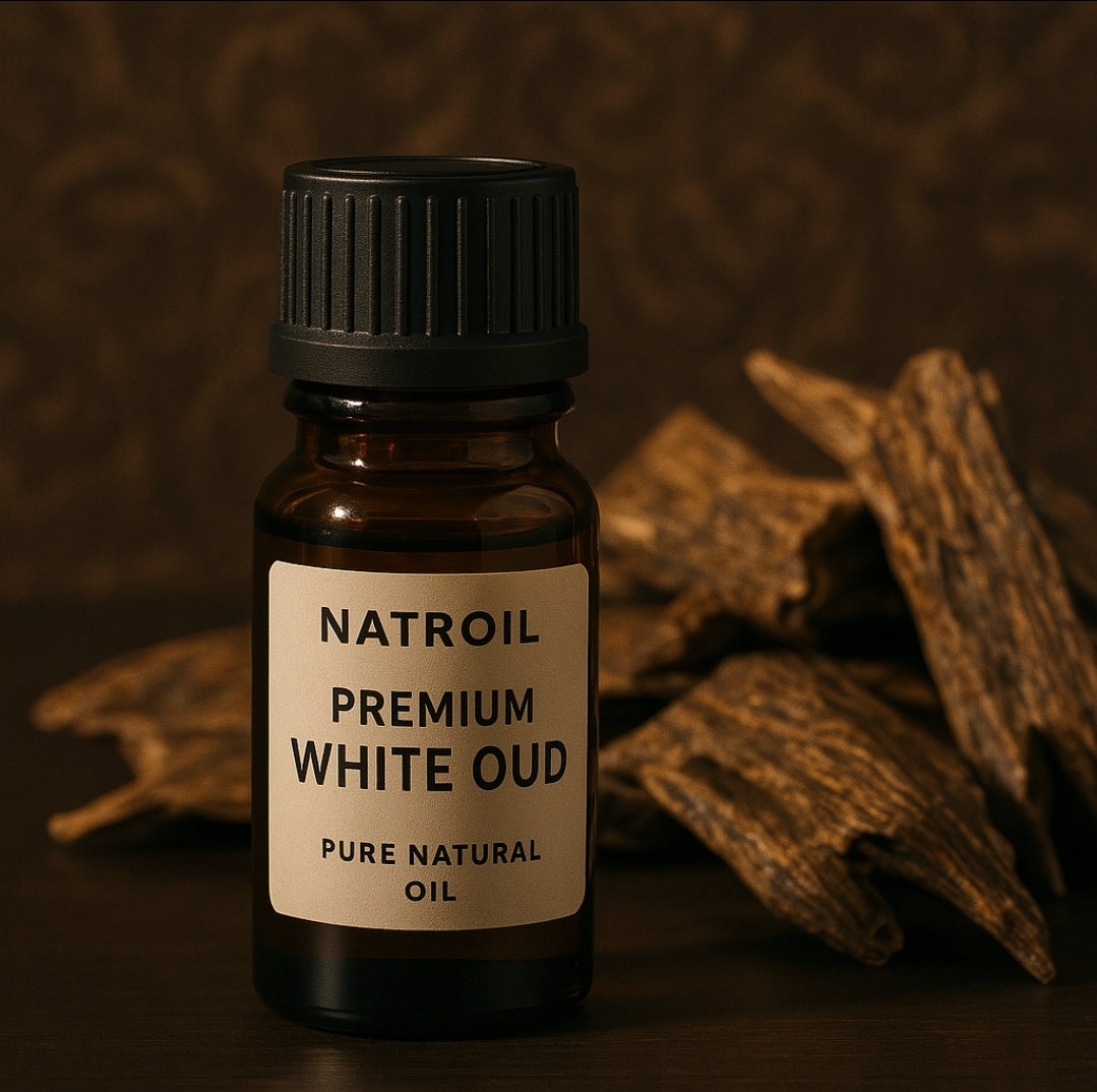 Premium White Oud essential oil by Natroil with oud wood chips in a high-end setting